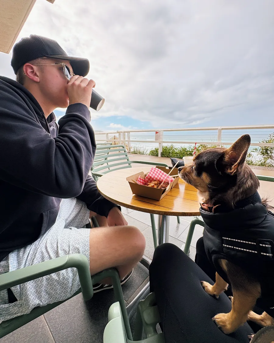 Cameron having a coffee by the beach