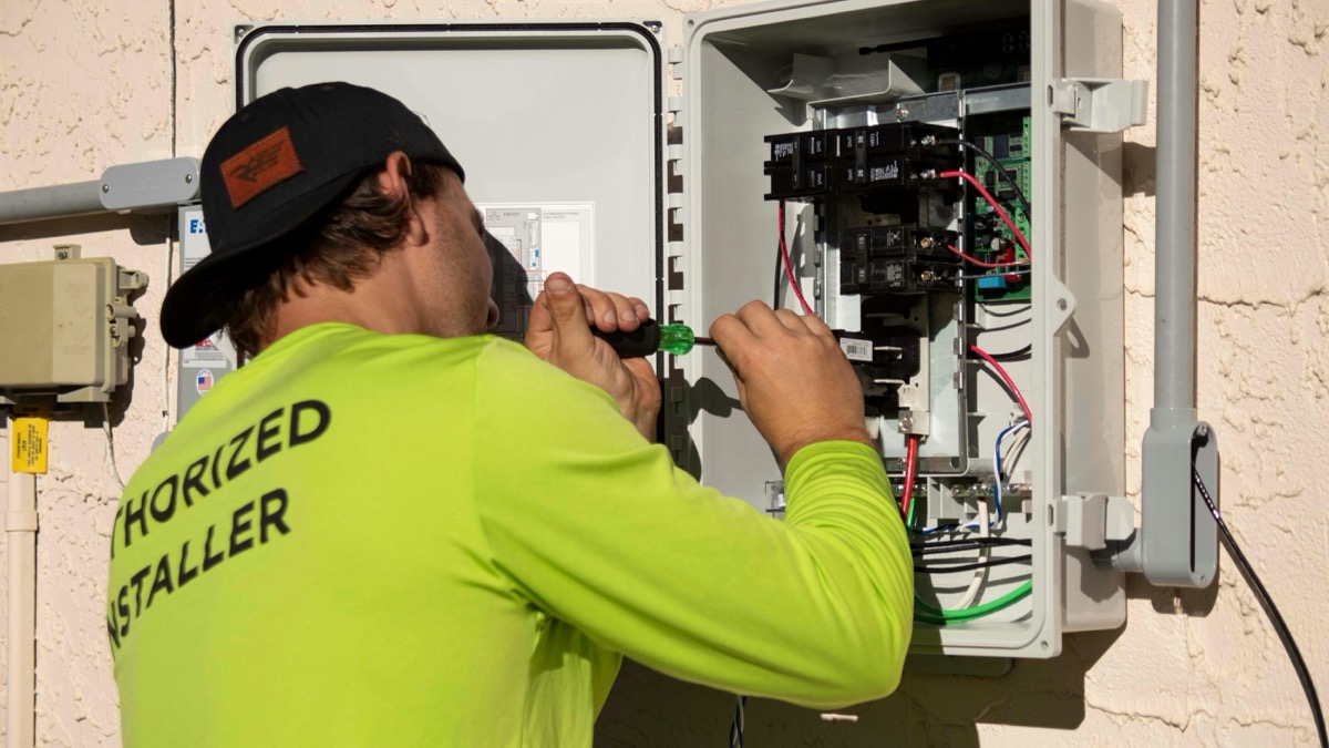 An electrician working on a switchboard