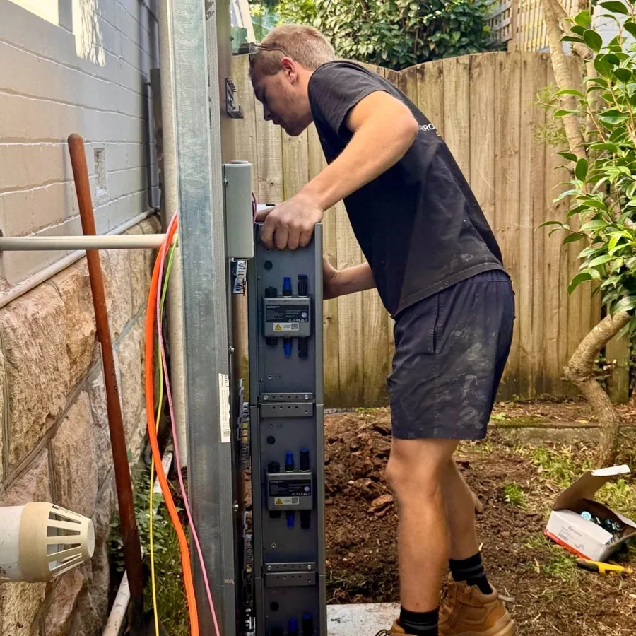 Electrician fitting a new switchboard on site